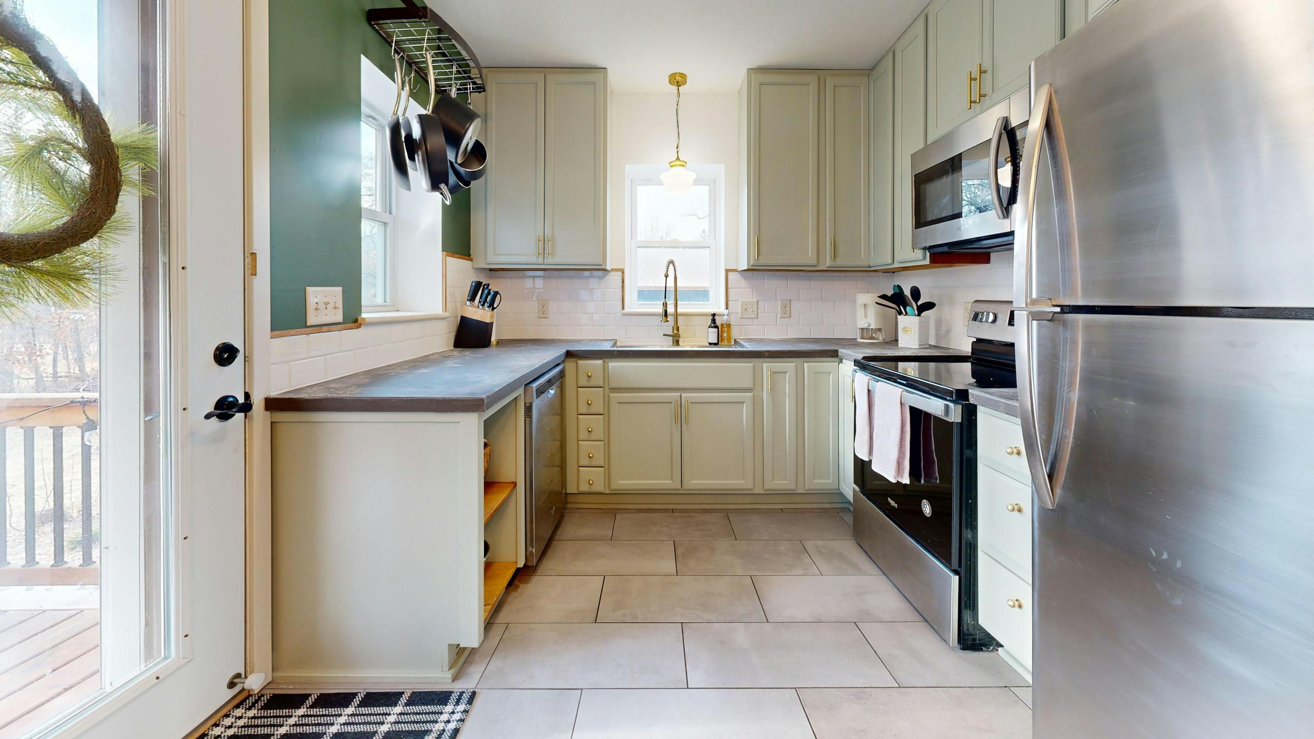 Bright modern kitchen with stainless steel appliances and elegant design.